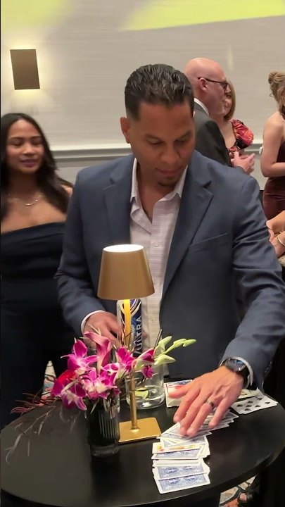 A guest at a corporate event picking a card from a spread on the table