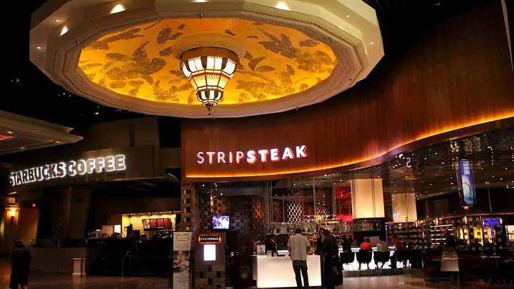 The lit StripSteak sign and host stand inside Mandalay Bay, Las Vegas